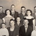 (X)  Eugene and Mary Woida Family Photo.  Back row L to R:  Benedict (1930-1996), Richard (1934-2018), Clifford (1932-2019), Eugene (1931-2010).  Middle row L to R:  Philip (1939-1999), Elreen (1935 - ), Myron (1943 - ), Esther (1928-2021), Leonard (1936 - ).  Front row L to R:  Aloysius (1946 - ), Mary (1902-1979), Eugene (1889-1961), George (1947 - )